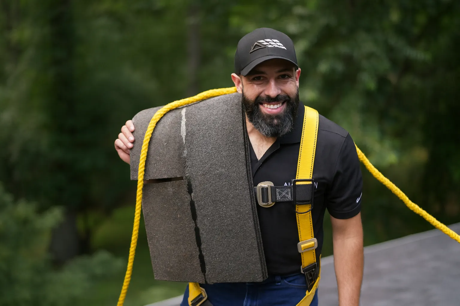 crew carrying shingles by American Home Contractors near McLean