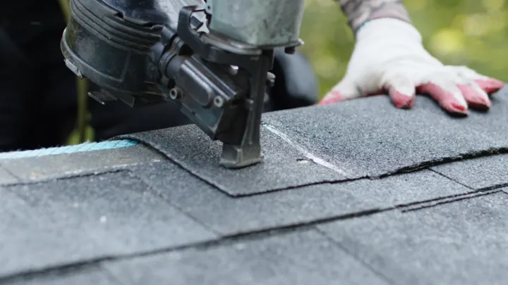 shingle nail gun closeup by American Home Contractors near Odenton